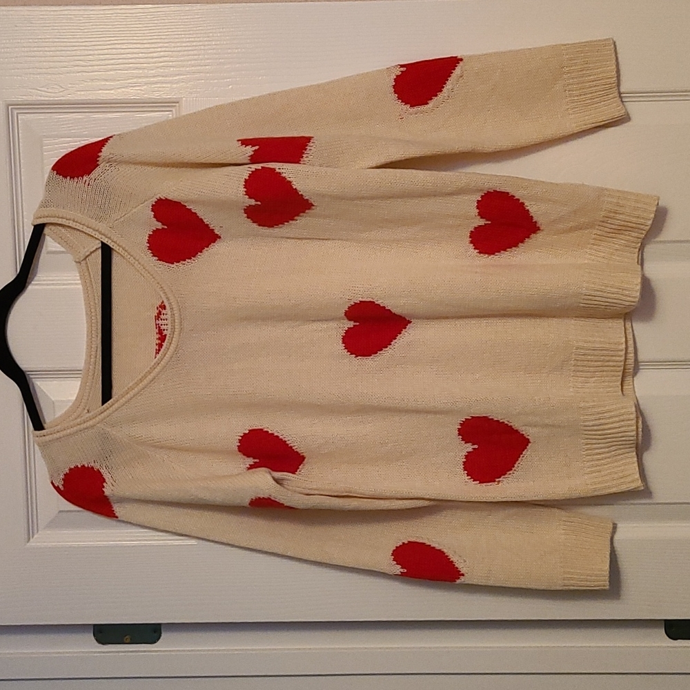 Cream sweater with red hearts.